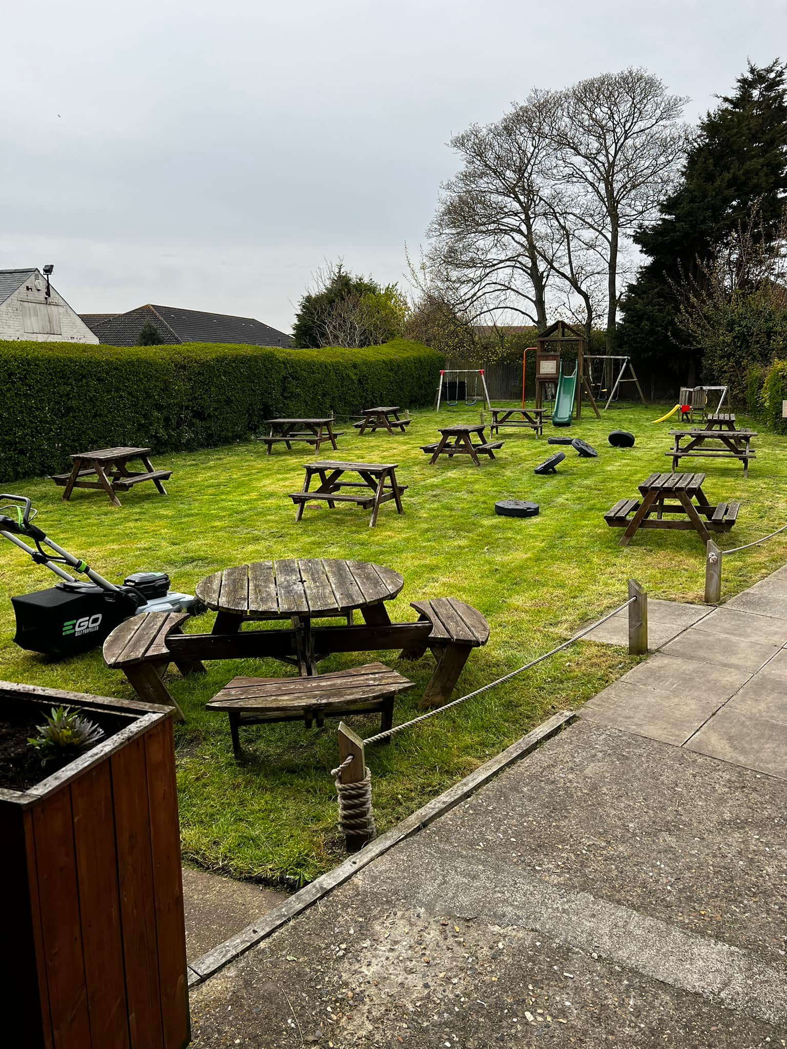 Large garden with wooden seats