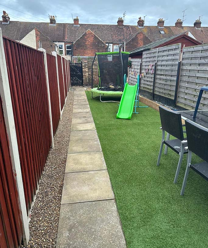 Patio slabs added to garden walkway and artificial turf added.